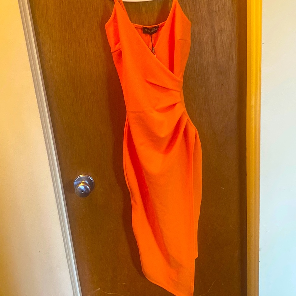 This is a orange casual dress with a slit on the side never been warn